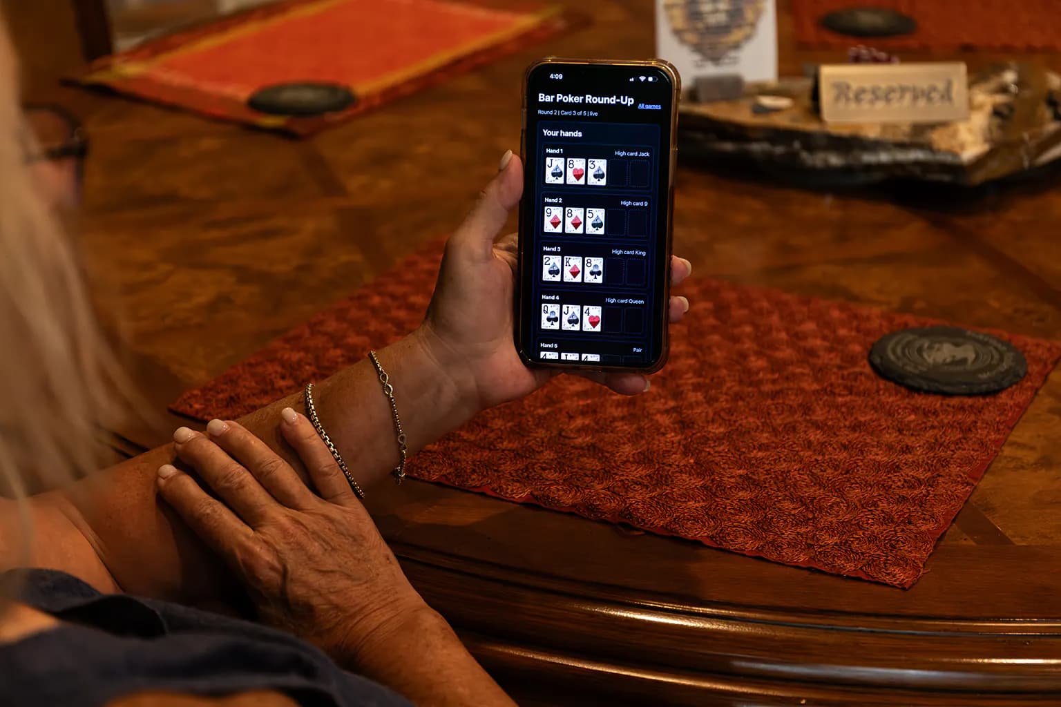 Bar Poker player hand experience on a phone